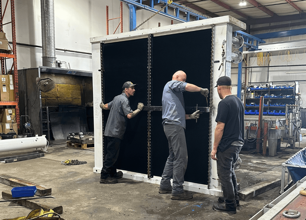 Shop technicians repairing a leaky back-up generator